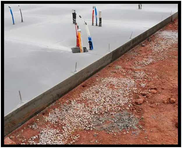 A concrete slab with gravel and sand on it.