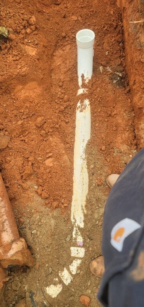 A person standing on top of dirt ground.