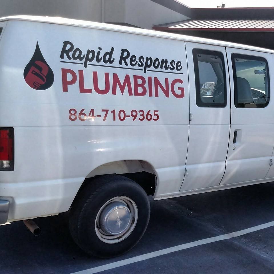 A white van with the words rapid response plumbing on it.